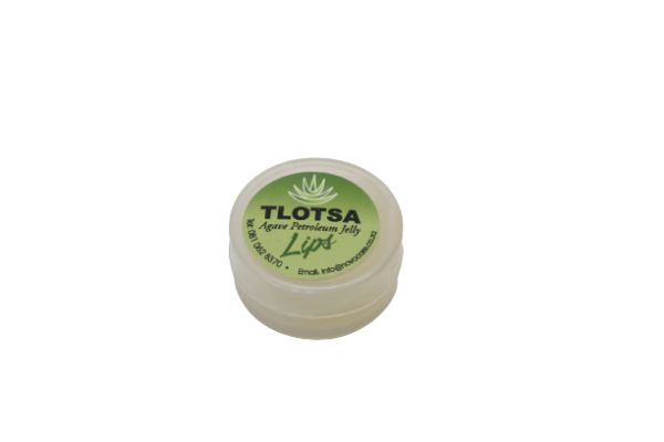 Close-up of Tlotsa Lip balm 5g packaging, highlighting its compact size and the natural Agave ingredient emphasized on the label for moisturized and soft lips.